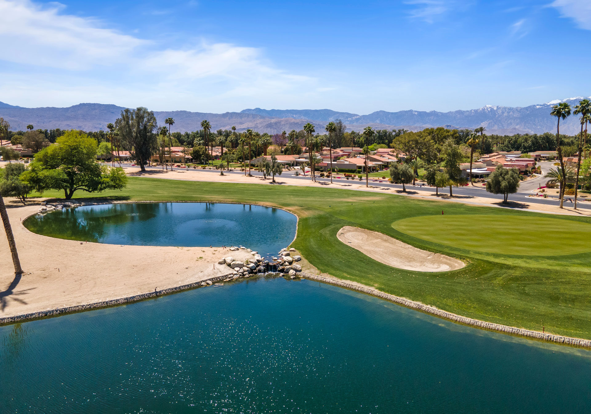 Aerial view of Palm Desert in California with blue lakes, homes and lots of palm trees
