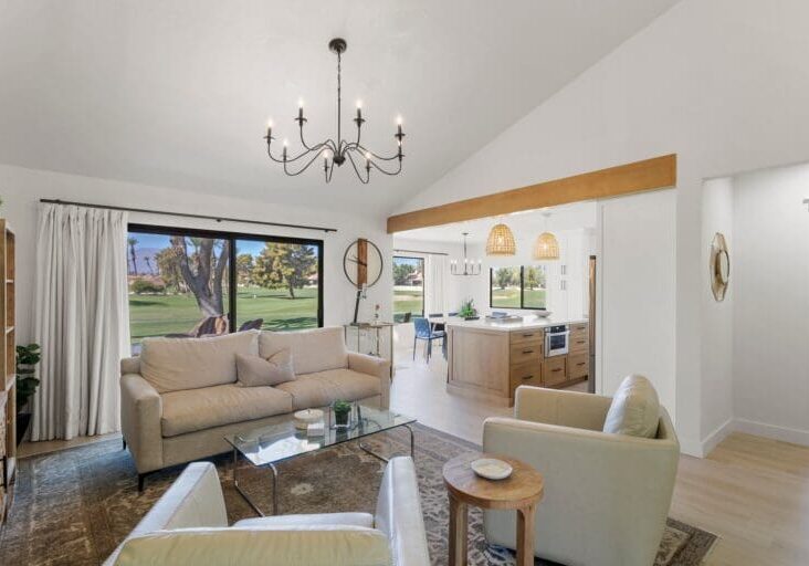 Living area with white couches overlooking the kitchen at 41443 Inverness Way