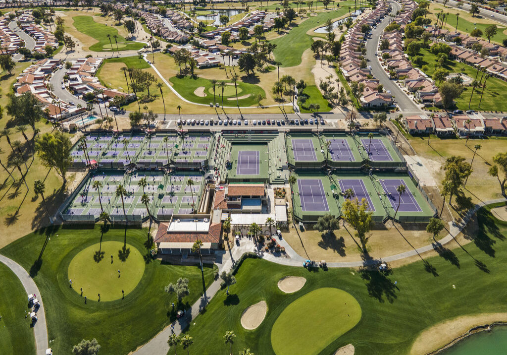 Aerial view of tennis courts and housing community at 41443 Inverness Way