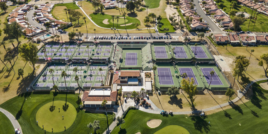 Aerial view of tennis courts and housing community at 41443 Inverness Way